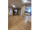 Open layout with new flooring flowing from kitchen featuring stainless steel appliances and white cabinets to a dining area at 816 Drane Nw St, Plant City, FL 33563