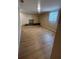 Empty living room with wood-look floors, a built-in shelf, and a window with blinds at 816 Drane Nw St, Plant City, FL 33563