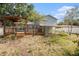 Large backyard featuring a deck and partial fencing with mature trees at 8212 Malvern Cir, Tampa, FL 33634