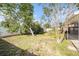 Spacious backyard with mature trees and a white picket fence, creating a private outdoor space at 8212 Malvern Cir, Tampa, FL 33634