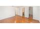 Bedroom with hardwood floors, with a view into an ensuite bathroom and closet at 8212 Malvern Cir, Tampa, FL 33634