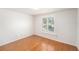 Cozy bedroom featuring a window with views of the outdoors and hardwood floors at 8212 Malvern Cir, Tampa, FL 33634