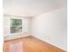 A bright bedroom with hardwood floors and a window overlooking the yard at 8212 Malvern Cir, Tampa, FL 33634