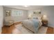 Cozy bedroom featuring hardwood floors, plantation shutters, and neutral decor for relaxation at 8212 Malvern Cir, Tampa, FL 33634