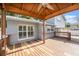 Back deck with a wood gazebo, ceiling fan and outdoor seating area at 8212 Malvern Cir, Tampa, FL 33634