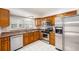 Modern kitchen with stainless steel appliances, wood cabinets, and stone countertops at 8212 Malvern Cir, Tampa, FL 33634
