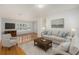 Bright living room with hardwood floors, plantation shutters, and a comfortable seating arrangement at 8212 Malvern Cir, Tampa, FL 33634