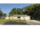 Charming home with well-maintained lawn, attached garage, and inviting curb appeal situated in a peaceful neighborhood at 834 Anchorage Ln, Palm Harbor, FL 34685