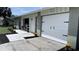 Exterior of a well-maintained home featuring a modern garage door, beautiful landscaping, and inviting curb appeal at 834 Anchorage Ln, Palm Harbor, FL 34685