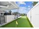 Landscaped backyard featuring a putting green, outdoor kitchen, and view of the waterway at 8706 Driftwood Dr, Tampa, FL 33615
