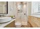 Modern bathroom featuring a glass-enclosed shower, vessel sink and vanity, neutral color palette, and natural light at 8706 Driftwood Dr, Tampa, FL 33615