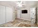 Bedroom with stylish tile floors, ceiling fan, and ensuite bath at 8706 Driftwood Dr, Tampa, FL 33615