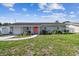 Charming single-story home with a well-maintained lawn and a bright pink front door at 8706 Driftwood Dr, Tampa, FL 33615