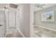 Hallway leading to a bedroom, showcasing a neutral color scheme and ceiling lighting at 8706 Driftwood Dr, Tampa, FL 33615