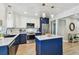 Bright kitchen featuring navy blue cabinets, stainless steel appliances, and white quartz countertops with a central island at 8706 Driftwood Dr, Tampa, FL 33615