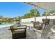 Outdoor patio with seating area overlooking a pool, canal and lush landscaping at 8706 Driftwood Dr, Tampa, FL 33615