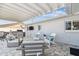 Covered patio with comfortable seating, a television, and a grill at 8706 Driftwood Dr, Tampa, FL 33615