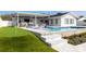 Outdoor pool featuring a putting green, outdoor bar, and comfortable seating at 8706 Driftwood Dr, Tampa, FL 33615