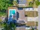 A beautiful aerial view of a home featuring a pool and solar panels for energy efficiency at 9086 Enchantment Dr, Largo, FL 33773