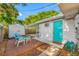 Inviting backyard deck area featuring comfortable seating, shed, and a vibrant, colorful door at 9086 Enchantment Dr, Largo, FL 33773