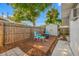 Relaxing backyard deck showcasing outdoor seating, a wooden fence, and a peaceful ambiance at 9086 Enchantment Dr, Largo, FL 33773