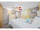 Bright bedroom offers wood-look floors, ceiling fan, and a chest of drawers at 9086 Enchantment Dr, Largo, FL 33773