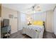 Cozy bedroom featuring natural light, ceiling fan, and wood-look flooring at 9086 Enchantment Dr, Largo, FL 33773