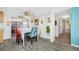Cozy dining area with unique decor, a ceiling fan, and grey wood-look flooring at 9086 Enchantment Dr, Largo, FL 33773