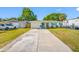 Inviting home with a turquoise front door, matching shutters, and an RV parked in the driveway at 9086 Enchantment Dr, Largo, FL 33773