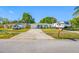 Quaint home with a cozy exterior, a well-maintained lawn, and an RV parked next to the driveway at 9086 Enchantment Dr, Largo, FL 33773