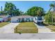 Well-maintained home with a neat lawn and an RV parked in the driveway at 9086 Enchantment Dr, Largo, FL 33773