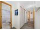 Hallway featuring wood-look floors, closet, and entry to updated bathroom at 9086 Enchantment Dr, Largo, FL 33773
