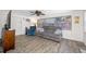 Comfortable living room features wood-look flooring, ceiling fan, and plenty of natural light at 9086 Enchantment Dr, Largo, FL 33773