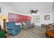 Cozy living room with ceiling fan, wood-look flooring, and lots of natural light at 9086 Enchantment Dr, Largo, FL 33773