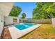 Inviting in-ground pool surrounded by a well-maintained yard and a privacy fence at 9086 Enchantment Dr, Largo, FL 33773