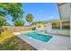 Inviting swimming pool with a concrete surround, offering a refreshing oasis in the backyard at 9086 Enchantment Dr, Largo, FL 33773
