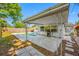 Beautiful backyard showcasing a swimming pool, covered patio, and outdoor grill area at 9086 Enchantment Dr, Largo, FL 33773