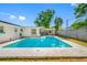 Large swimming pool with a concrete surround, set in a private backyard oasis with lush greenery at 9086 Enchantment Dr, Largo, FL 33773