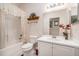 Well-maintained bathroom with a shower-tub combo, ample counter space, and neutral tones at 7519 Berna Ln, Land O Lakes, FL 34637