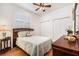 Cozy bedroom featuring wood floors, plantation shutters, and a tranquil atmosphere at 7519 Berna Ln, Land O Lakes, FL 34637