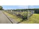 A delightful community garden with individual plots enclosed by a chain-link fence on a sunny day at 7519 Berna Ln, Land O Lakes, FL 34637