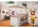 Open kitchen with white cabinets, granite counters, island, breakfast bar, and breakfast nook at 7519 Berna Ln, Land O Lakes, FL 34637