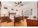 Spacious main bedroom features hardwood flooring, ceiling fan, and natural light at 7519 Berna Ln, Land O Lakes, FL 34637