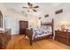 Main bedroom showcases hardwood floors, neutral walls, ceiling fan, and ample natural light at 7519 Berna Ln, Land O Lakes, FL 34637