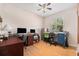 Bright office space with hardwood floors, large window, ceiling fan, and desk areas at 7519 Berna Ln, Land O Lakes, FL 34637