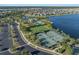Aerial view of the community amenities featuring tennis courts, a community pool, and a lake backdrop at 10005 Sage Creek Dr, Ruskin, FL 33573