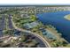 Aerial view highlighting the tennis and basketball courts plus the community pool near the picturesque lake at 10005 Sage Creek Dr, Ruskin, FL 33573