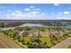 A high angle aerial view of community amenities and surrounding homes near a lake at 10005 Sage Creek Dr, Ruskin, FL 33573