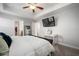 Relaxing bedroom includes a bed, wall mounted tv, and desk, perfect for a home office setup at 10005 Sage Creek Dr, Ruskin, FL 33573