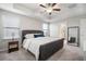 Comfortable bedroom boasts a bed, bedside table, large mirror and access to the bathroom at 10005 Sage Creek Dr, Ruskin, FL 33573
